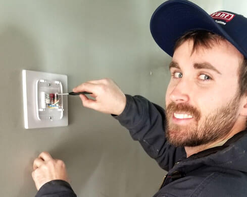 Tech working on a thermostat